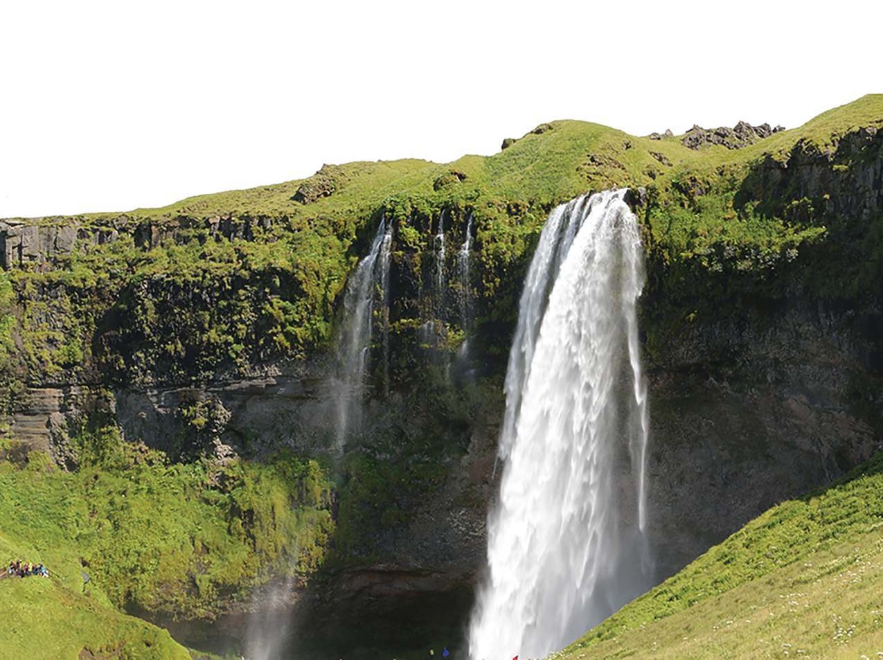 Seljalandsfoss waterfall pouring over moss-green cliffs in Iceland